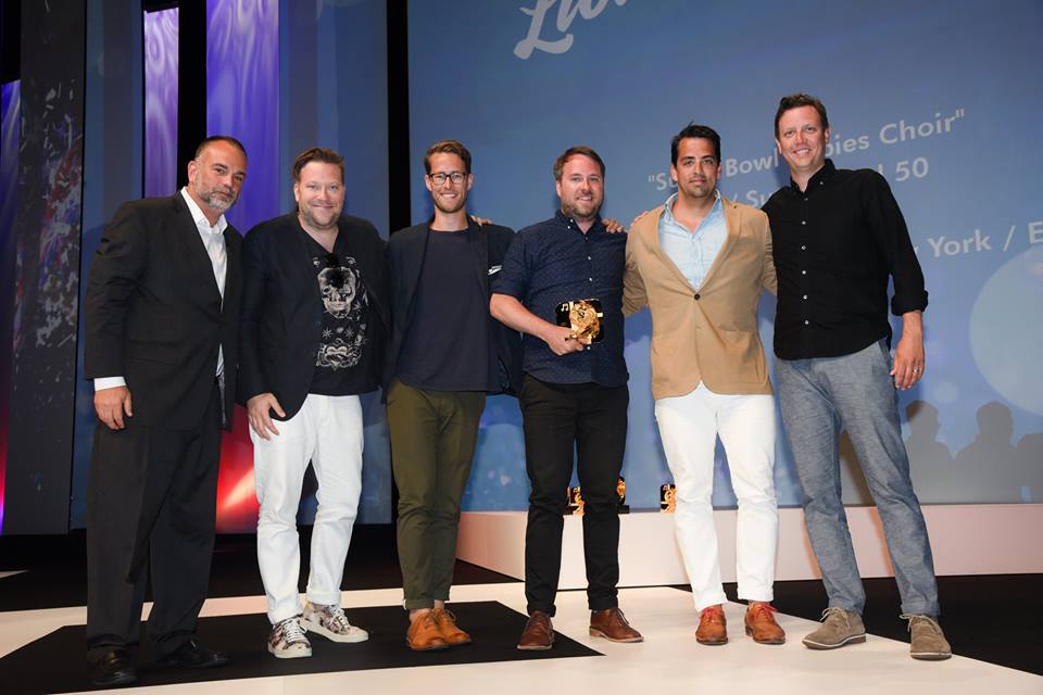 Josh Rabinowitz presenting the Grey New York team behind "Super Bowl Babies Choir" with their Bronze award.